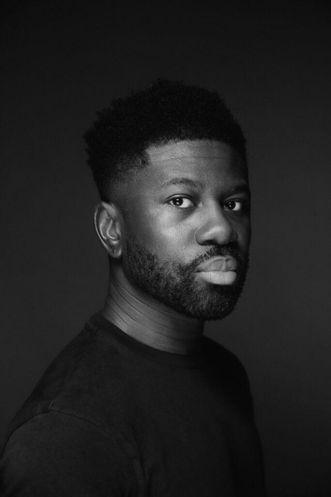 Black and white portrait of novelist Michael Odonkor in three quarter profile